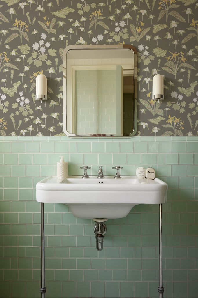 Vintage bathroom setting with the Forest Blooms Night-Time wallpaper complementing the sage green tile, illustrating the thawing forest ground and the season's first blooms.