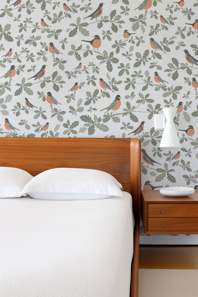 A tranquil bedroom setting featuring the Robin Silvery Grey wallpaper, creating a peaceful ambiance with the soft, springtime chirps of robin illustrations