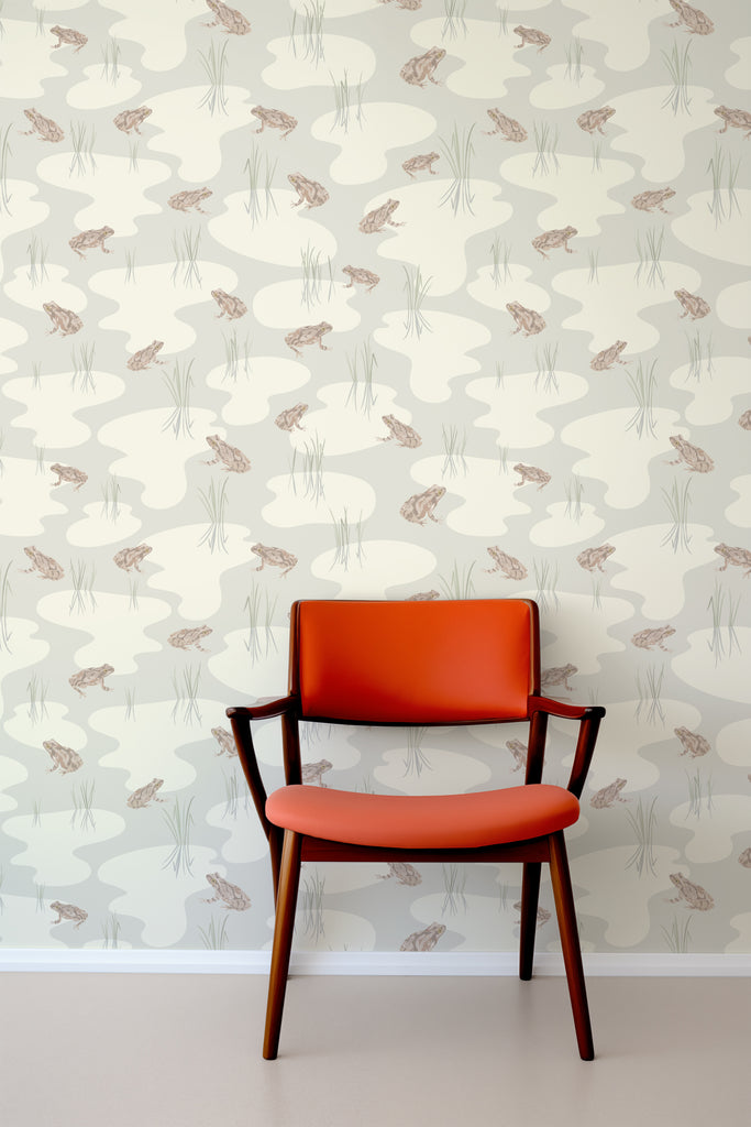 Designer leather chair set against Kate Golding's Spring Peeper Cream wallpaper, marrying luxury with nature-inspired design.