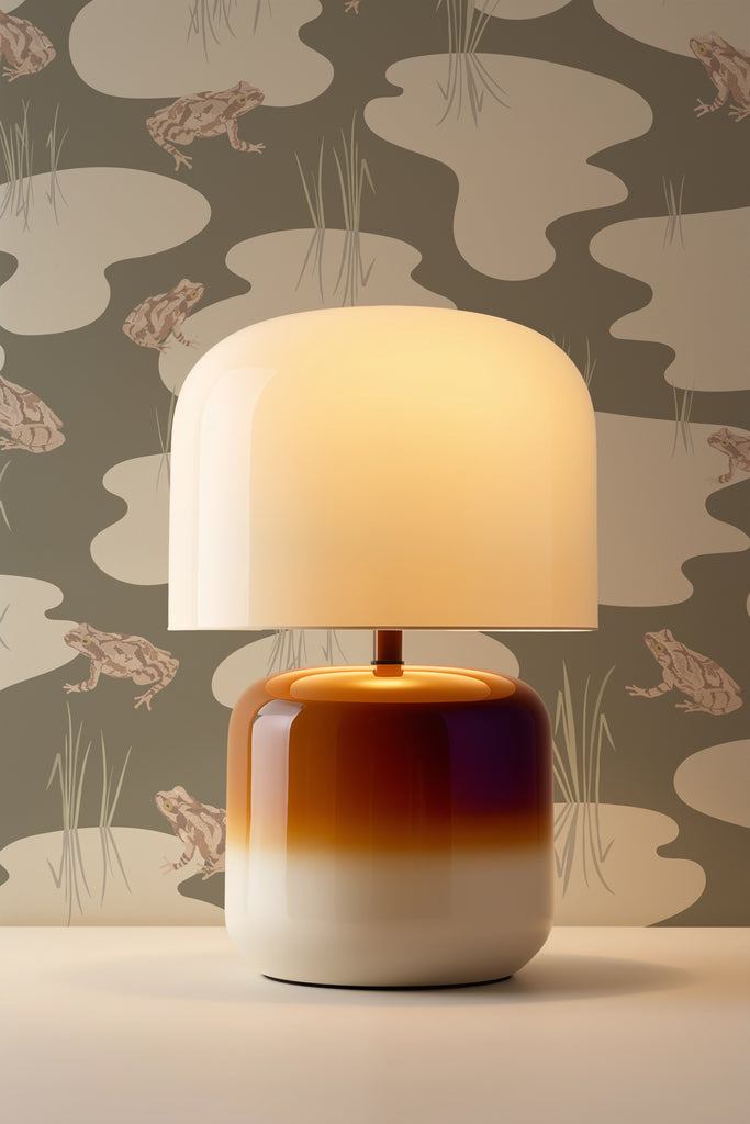 Post-modern tulip-style lamp illuminating Kate Golding's Spring Peeper Khaki wallpaper, accentuating the wallpaper's color and design with soft lighting.