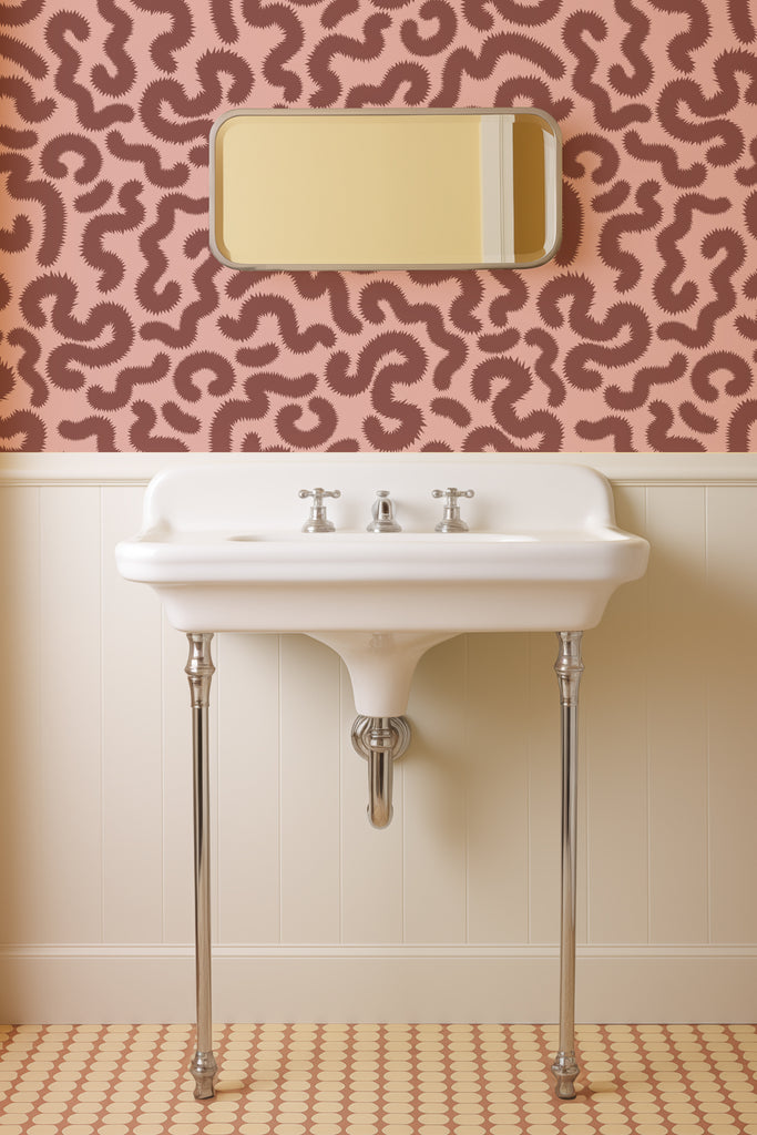Bathroom of a Spring Pop wallpaper in Oxblood and Pink by Kate Golding, highlighting the intricate caterpillar motif and color depth