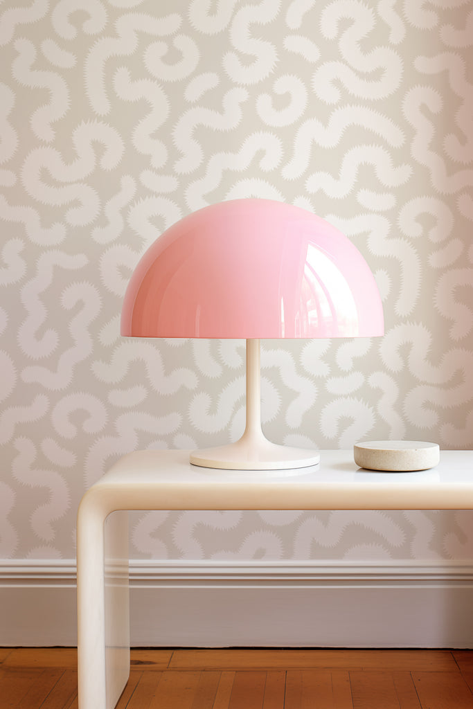 Kate Golding's Spring Pop Parchment wallpaper paired with a pink tulip lamp on a side table, illustrating a chic and harmonious decor combination