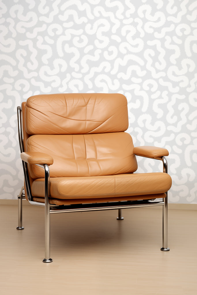 Chic taupe leather sofa set against Kate Golding's Spring Pop Silvery Grey wallpaper, blending modern luxury with playful design elements.